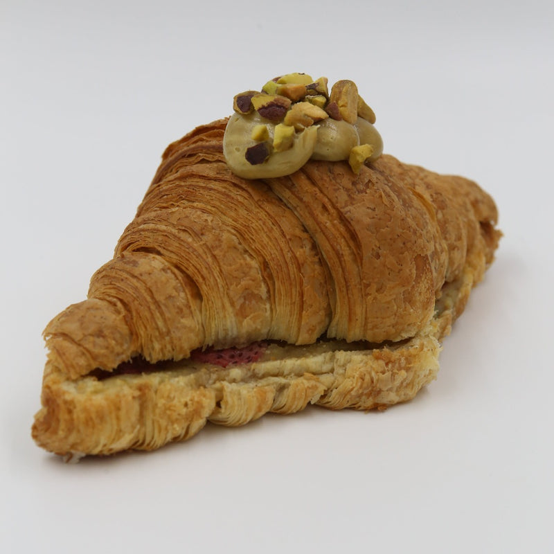 Pistachio Strawberry Twice Baked Croissant on a white background.