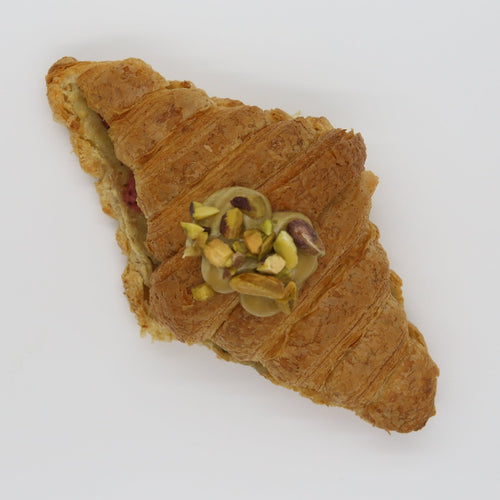 Pistachio Strawberry Twice Baked Croissant on a white background.