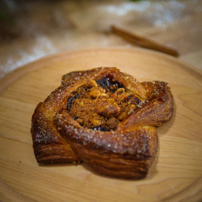 caramel Pear and goat cheese danish on a wooden plate