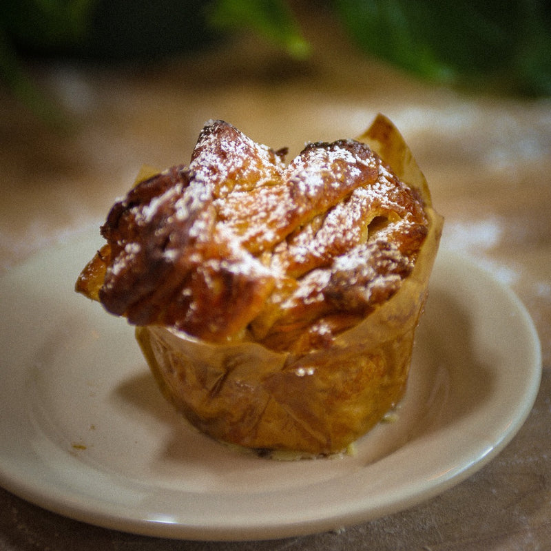 Cinnamon Sugar Monkey bread sitting on a plate in a bakery.