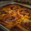 Cinnamon rolls in a pan in a bakery.
