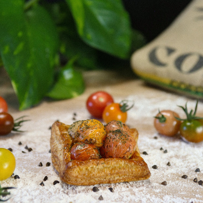 Tomato Puff Pastry on a baker's bench with flour.