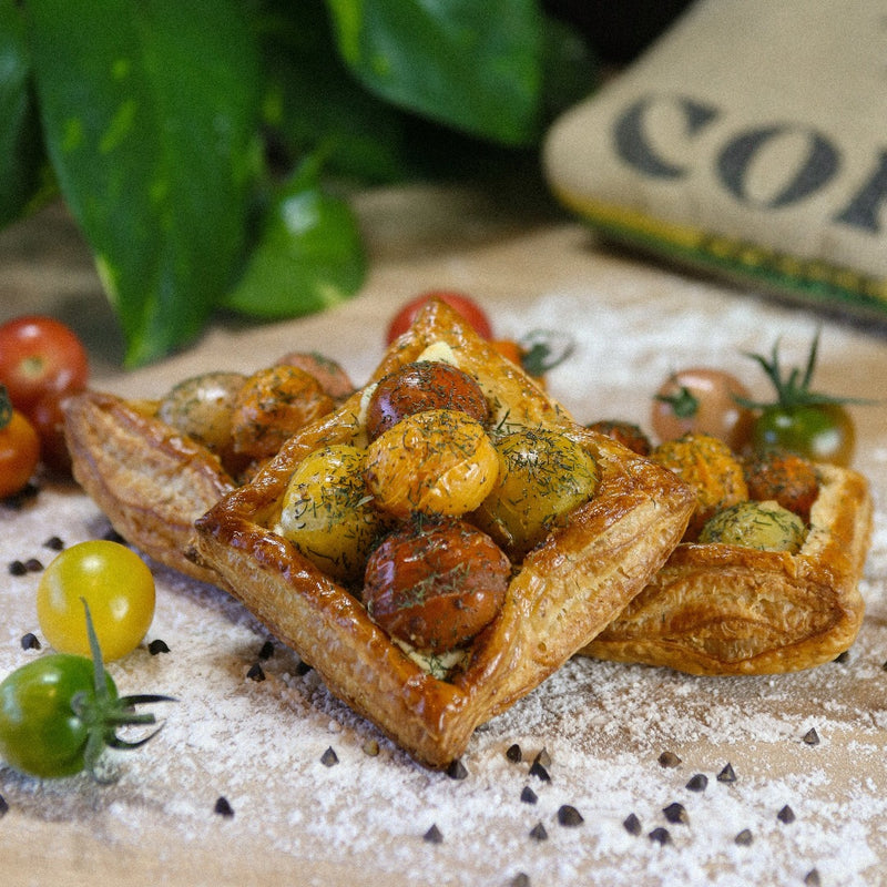 Tomato Puff Pastry on a baker's bench with flour.
