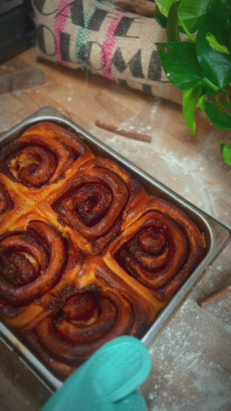 Cinnamon rolls being prepared and baked.